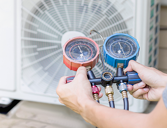 Person checking air conditioning gauges