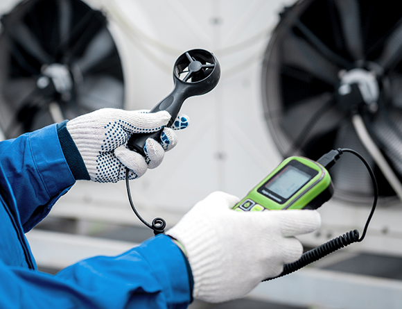 Person measuring air flow speed